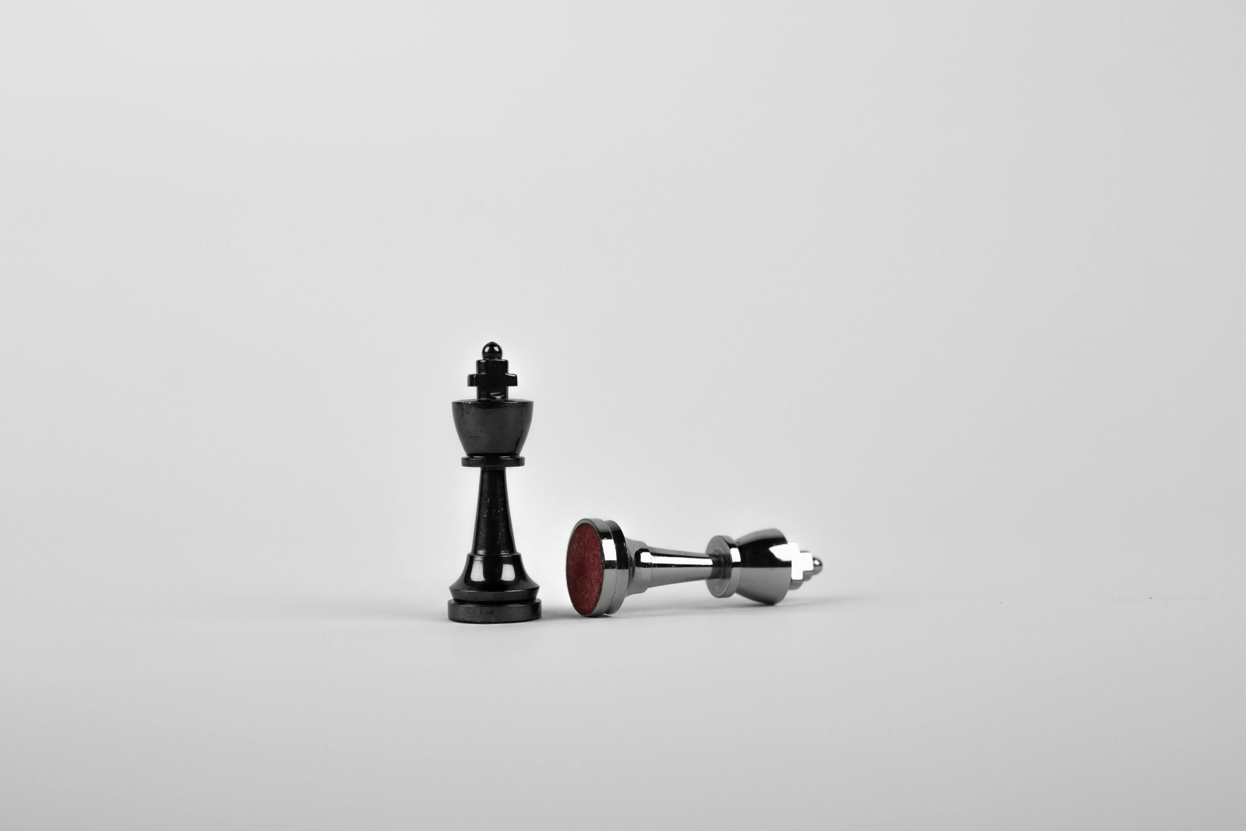 Close-up of chess king piece standing with a fallen piece symbolizing strategy and victory. digital marketing strategy